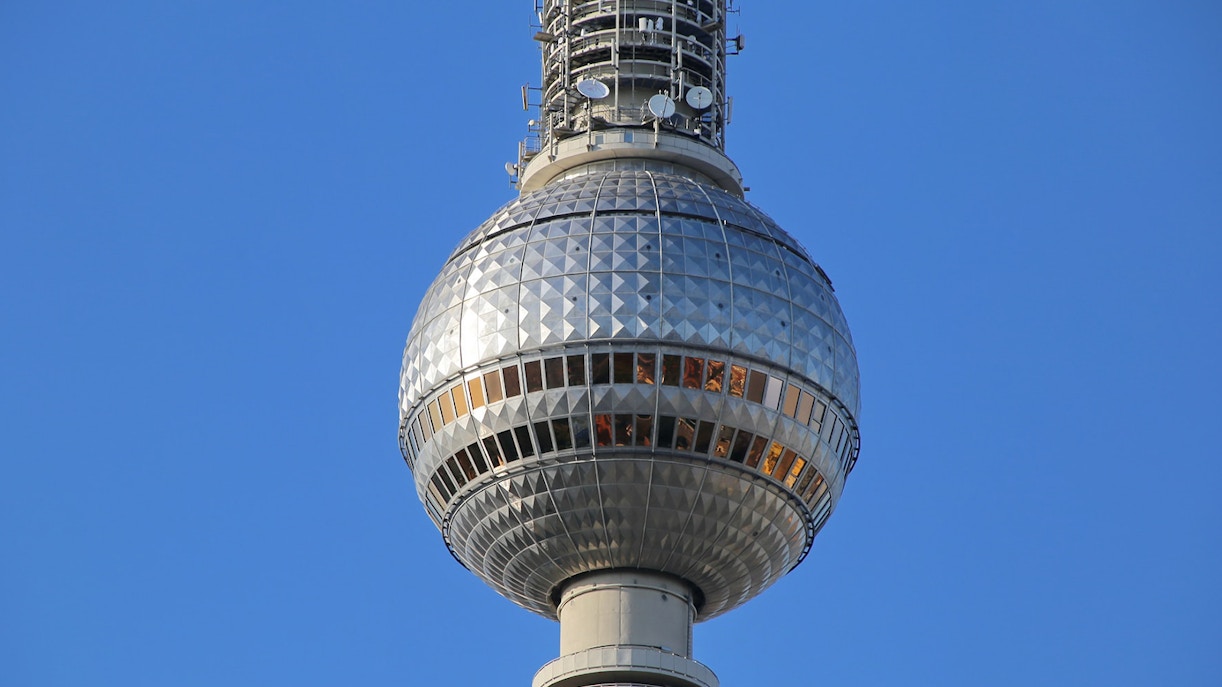 Berlin TV Tower observation deck against clear sky.