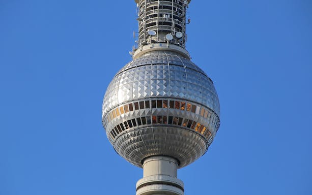Berlin TV Tower observation deck against clear sky.