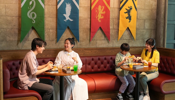 Harry Potter-themed cafe table with assorted food and beverages, London.