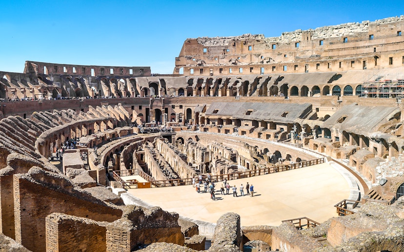 Visitors exploring the ancient Colosseum arena in Rome, Italy.