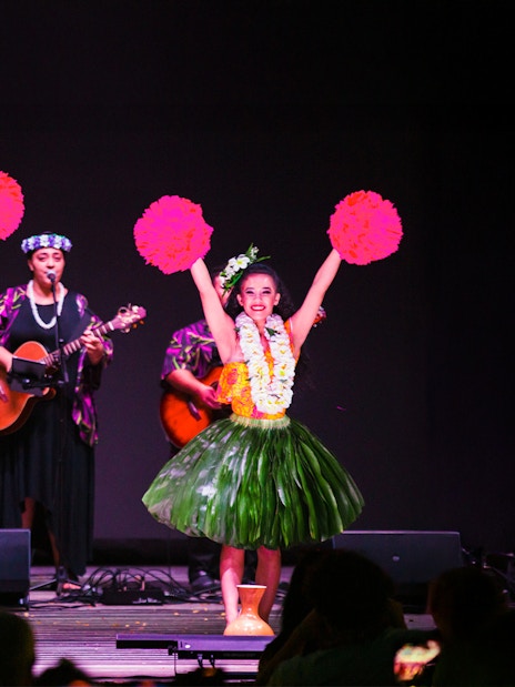 Performers at a traditional Hawaiian luau with musicians and hula dancers at Moana Luau, Hawaii.