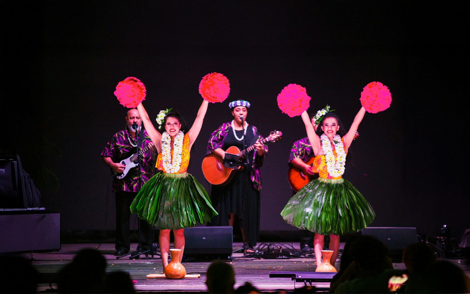 Performers at a traditional Hawaiian luau with musicians and hula dancers at Moana Luau, Hawaii.