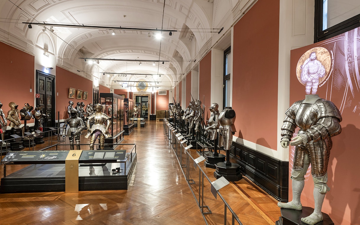 Armoury display inside New Hofburg Palace, featuring historical suits of armor.