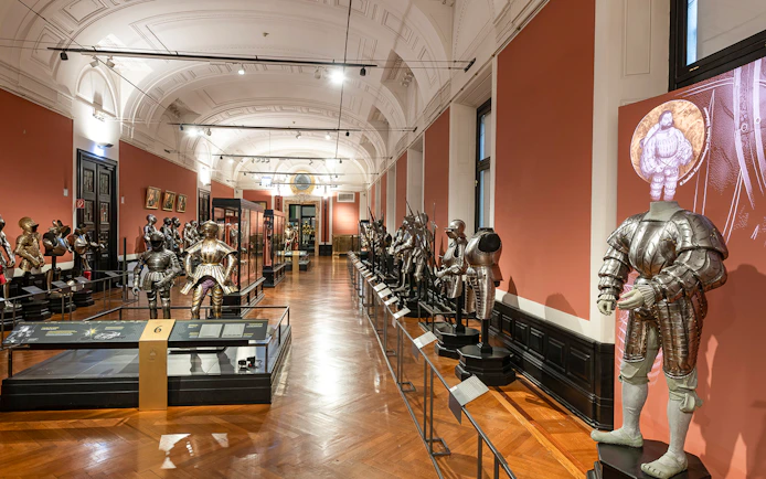 Armoury display inside New Hofburg Palace, featuring historical suits of armor.