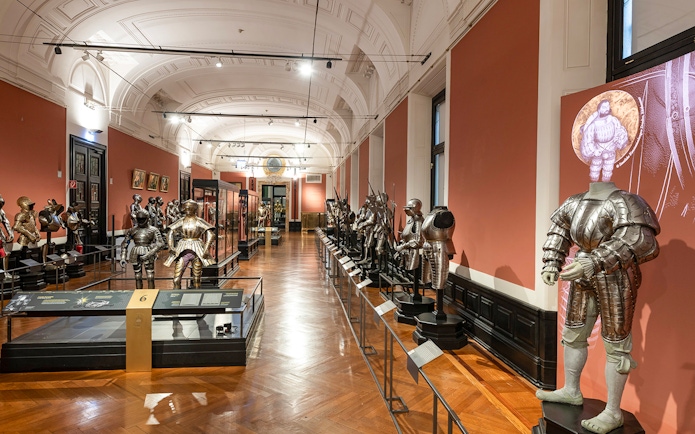 Armoury display inside New Hofburg Palace, featuring historical suits of armor.
