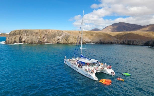 Ferry sailing from Fuerteventura to Lanzarote with passengers enjoying the view.