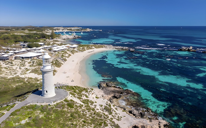 Rottnest Island coastline with lighthouse and turquoise waters, view from above.