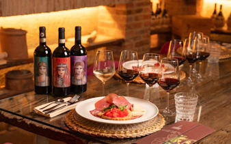 Wine tasting setup with Chianti bottles and Italian antipasto on a table during a Florence tour.