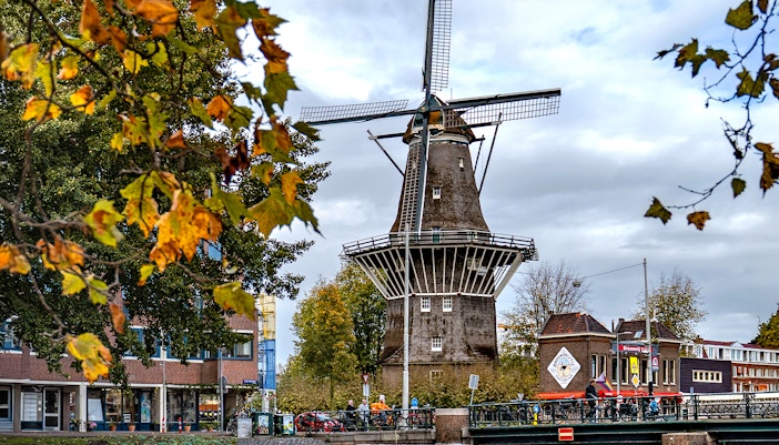 Windmill brewery in Amsterdam with people enjoying drinks outside.