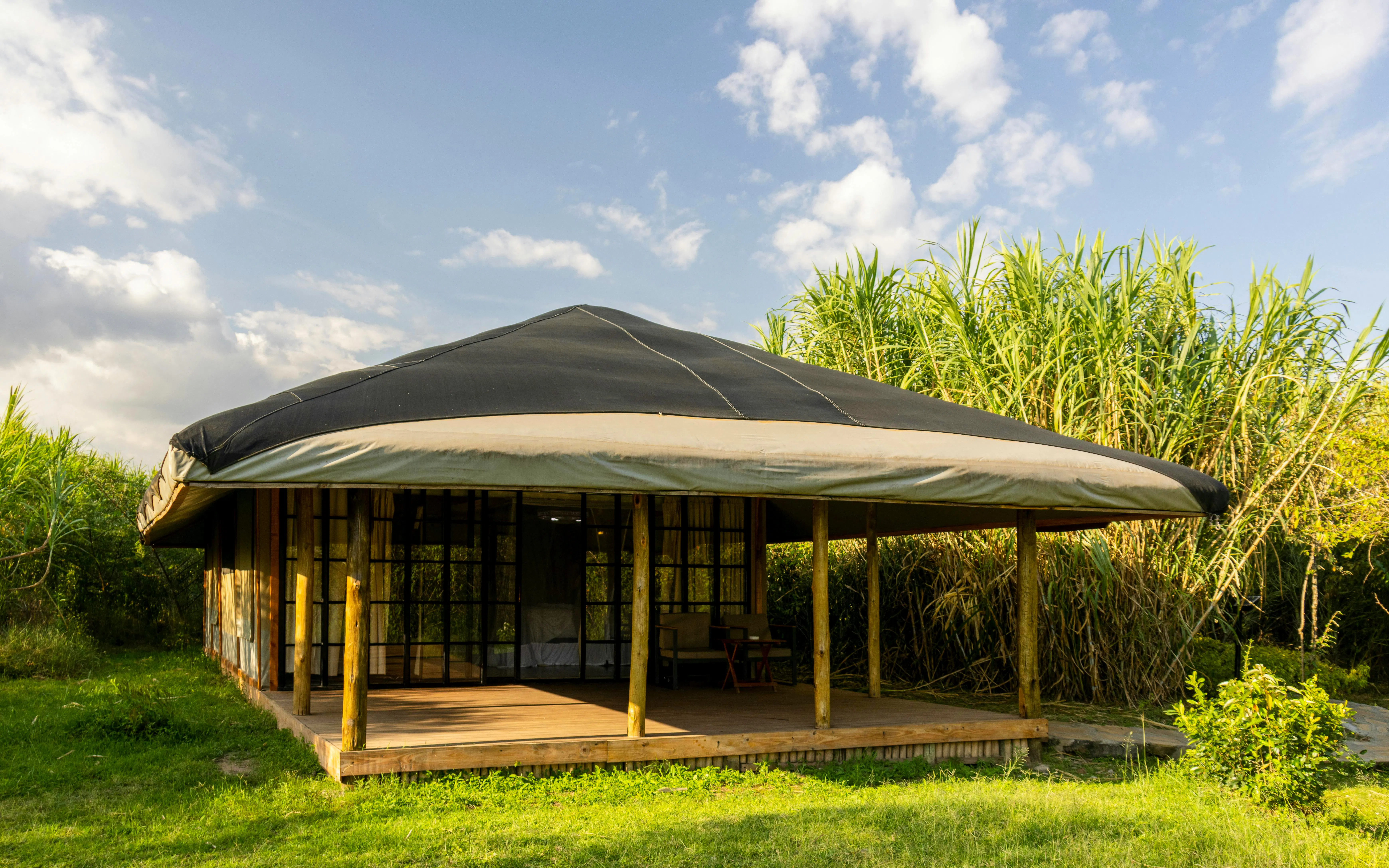 Luxury safari tent with wooden deck in Maasai Mara National Reserve, Kenya.