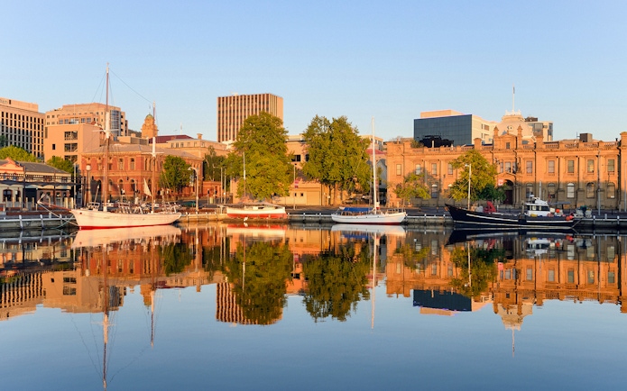 Hobart Docks with boats and historic buildings viewed from Derwent River cruise.