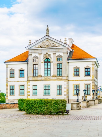 Fryderyk Chopin Museum building in Warsaw, Poland, with ornate facade and red roof.
