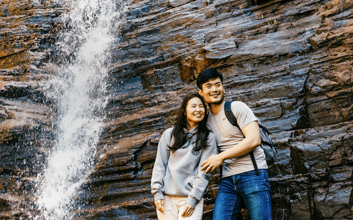 Couple smiling near Silverband Falls in Grampians National Park, Australia.