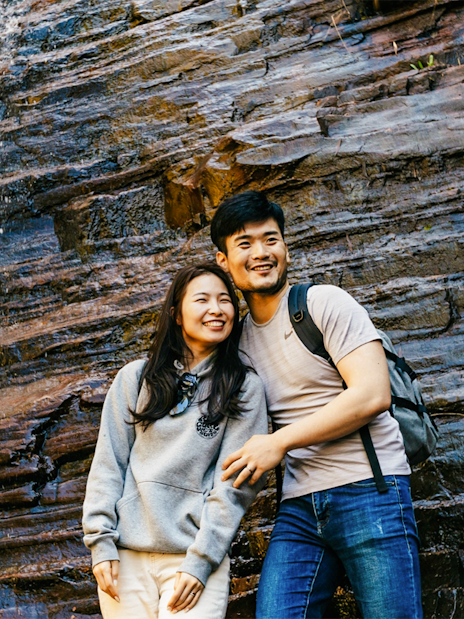 Couple smiling near Silverband Falls in Grampians National Park, Australia.