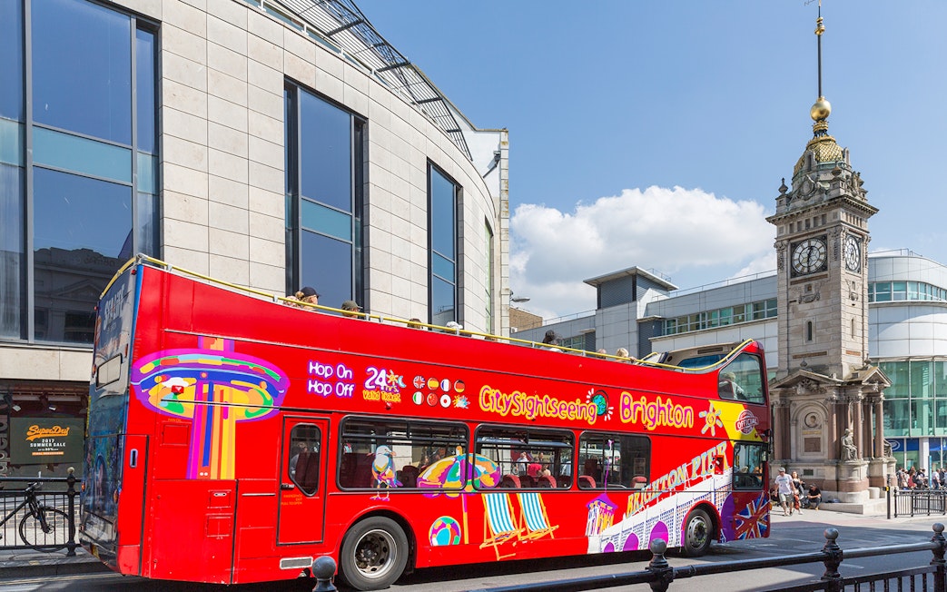 Open-top tour bus near Jubilee Clock Tower, Brighton.