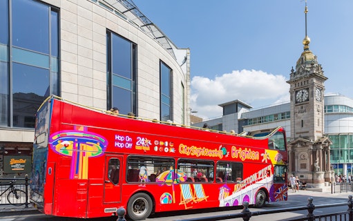 Open-top tour bus near Jubilee Clock Tower, Brighton.