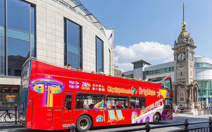 Open-top tour bus near Jubilee Clock Tower, Brighton.