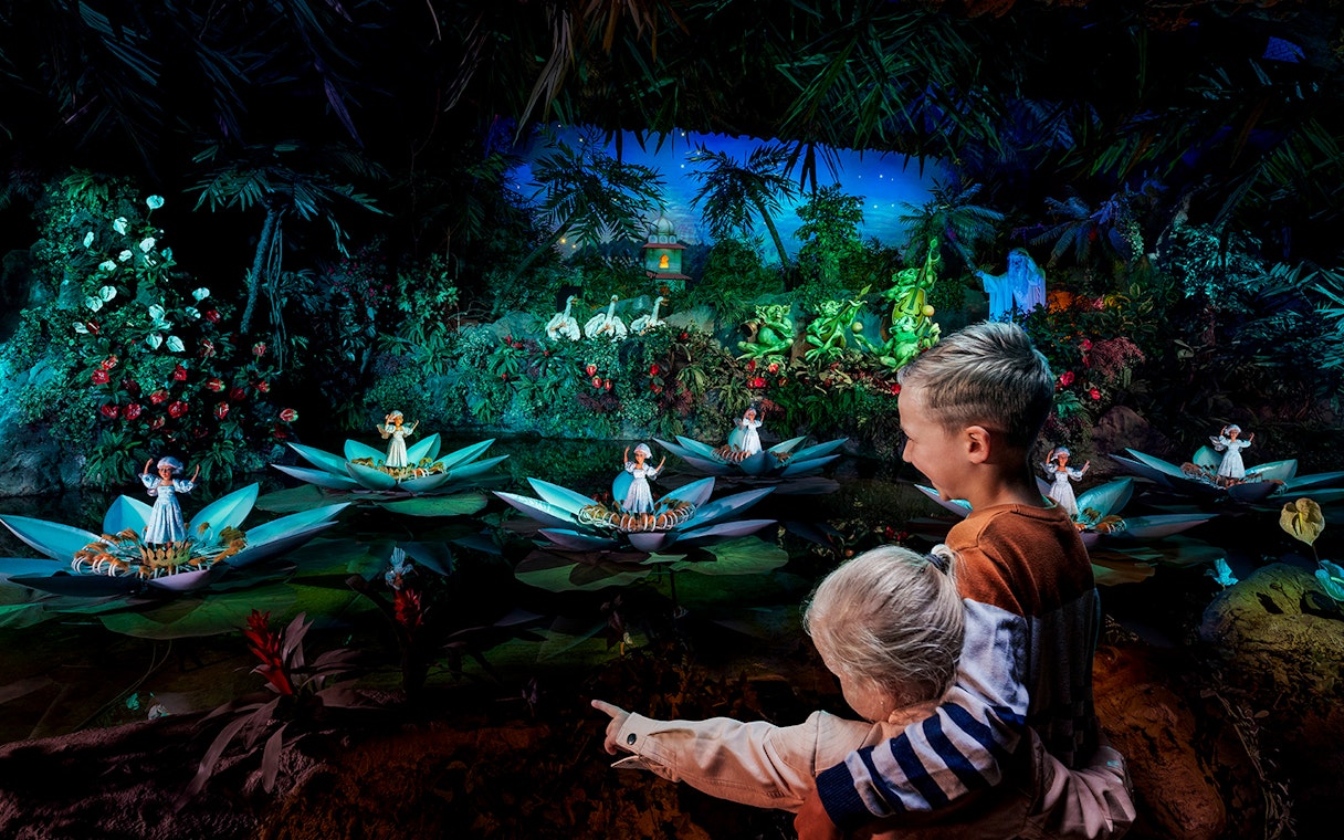 Children enjoying the fairy tale boat ride at Efteling theme park, Netherlands.