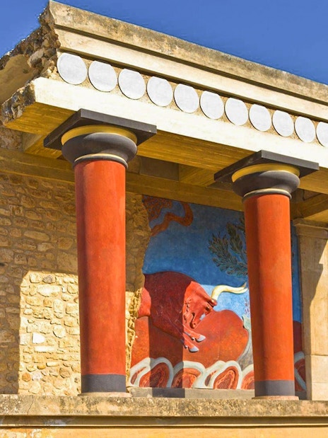 Knossos Palace ruins with red columns and fresco in Heraklion, Crete.