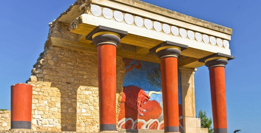 Knossos Palace ruins with red columns and fresco in Heraklion, Crete.