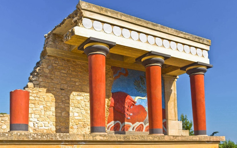 Knossos Palace ruins with red columns and fresco in Heraklion, Crete.