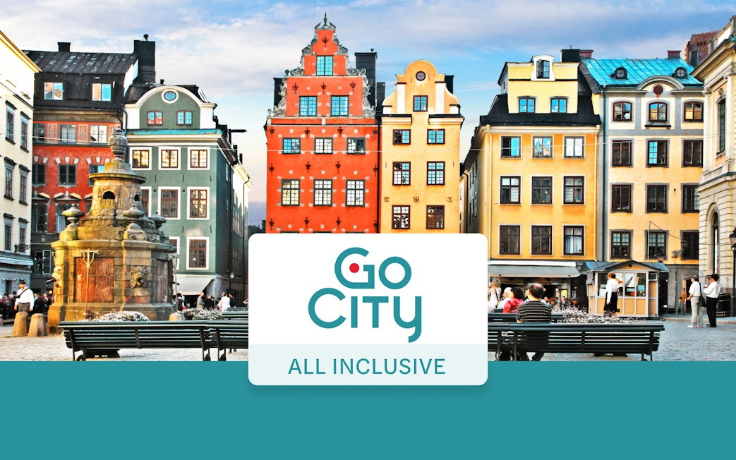 Colorful buildings in Stockholm's Gamla Stan with Go City All-Inclusive Pass sign.
