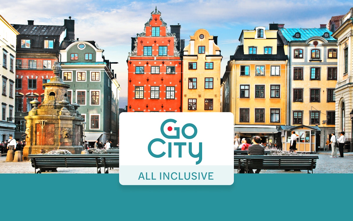 Colorful buildings in Stockholm's Gamla Stan with Go City All-Inclusive Pass sign.