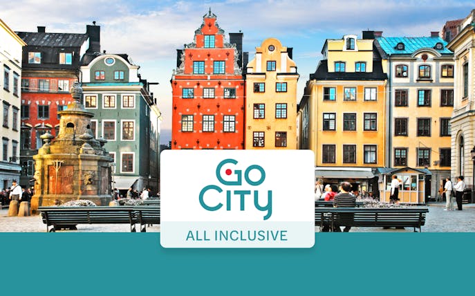 Colorful buildings in Stockholm's Gamla Stan with Go City All-Inclusive Pass sign.