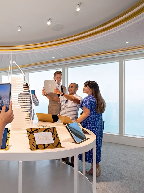 Guests exploring digital displays during Inside Burj Al Arab Tour at UMA Lounge.