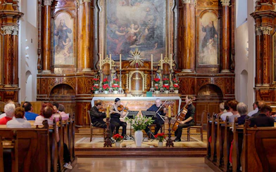 Musicians performing a classical concert inside Minoritenkirche, Vienna.