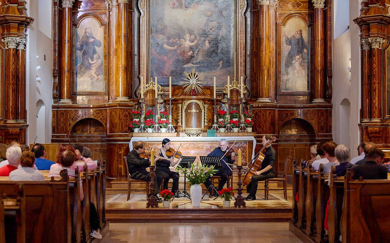 Musicians performing a classical concert inside Minoritenkirche, Vienna.