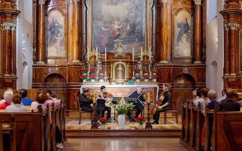 Musicians performing a classical concert inside Minoritenkirche, Vienna.