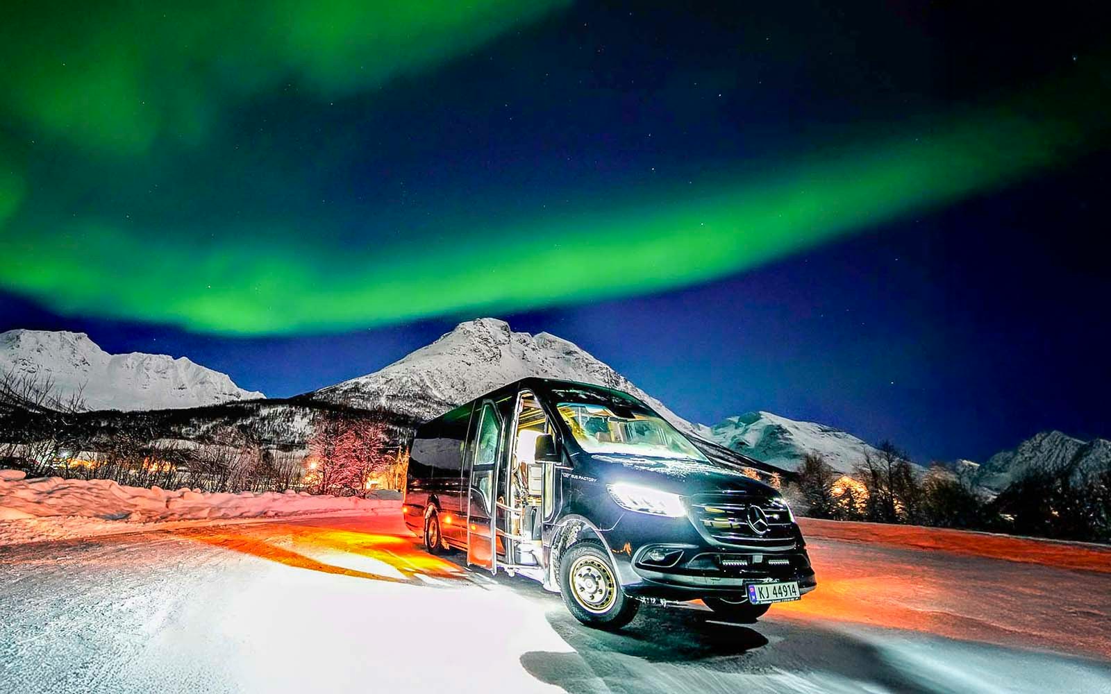 Van used in Northern Lights Chase Tours from Tromso under aurora borealis.