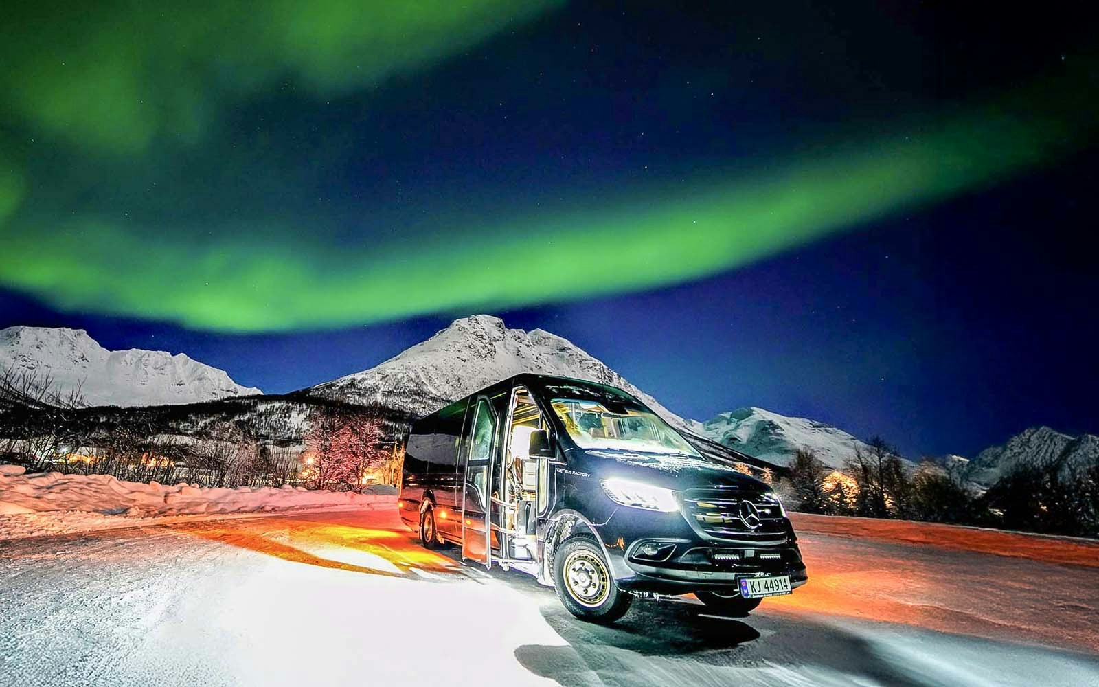 Van used in Northern Lights Chase Tours from Tromso under aurora borealis.