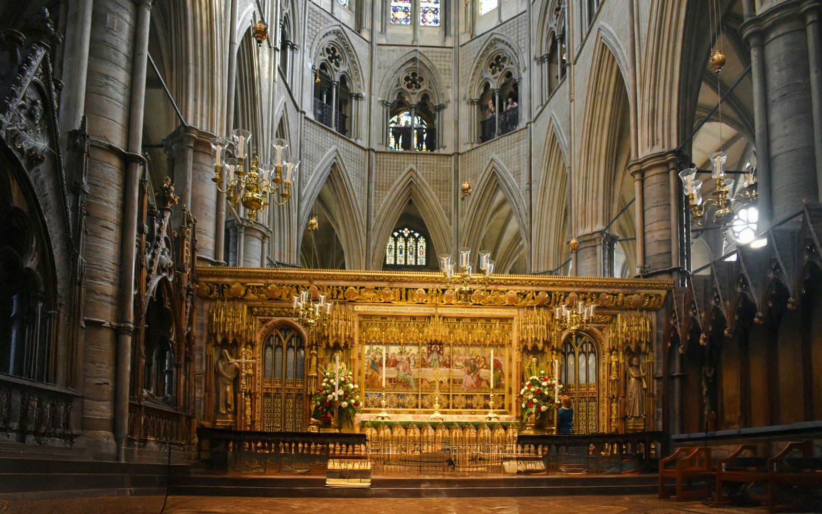 Interiors of Westminster Abbey with ornate altar and vaulted ceilings.