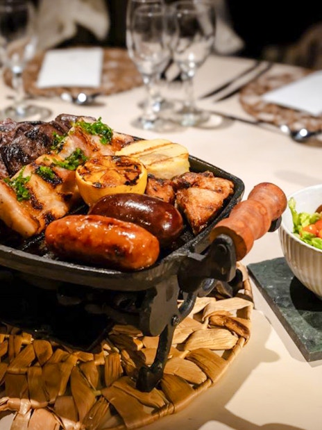 Grilled meats and salad served at Madero Tango Show in Buenos Aires.