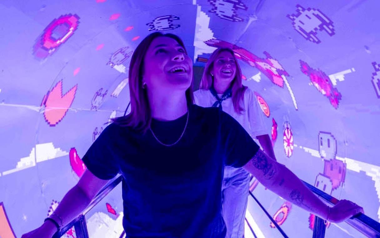 Visitors enjoying interactive digital art tunnel at Mind Games - Art Alive! exhibit.