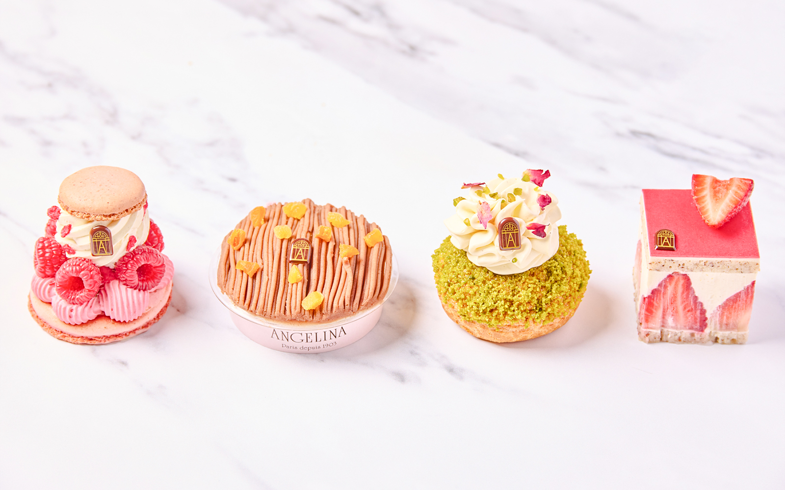 Selection of pastries at Angelina Rivoli, Paris, featuring macarons and fruit-topped desserts.