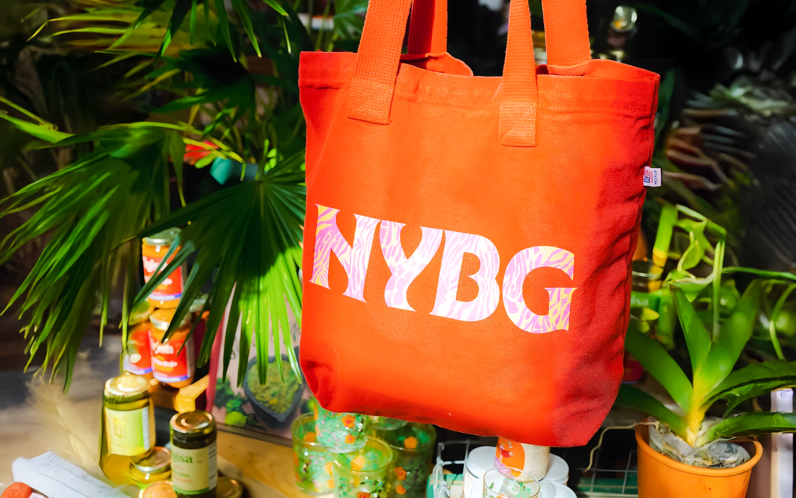NYBG tote bag displayed among plants and products at the shop.
