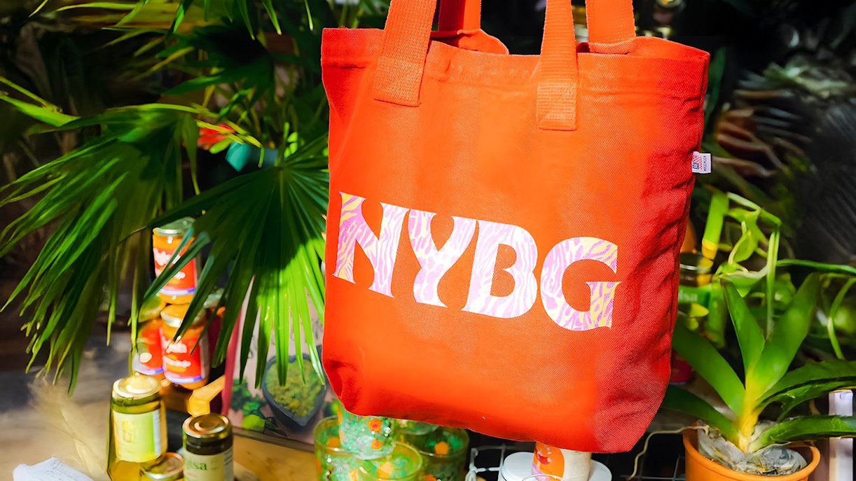NYBG tote bag displayed among plants and products at the shop.