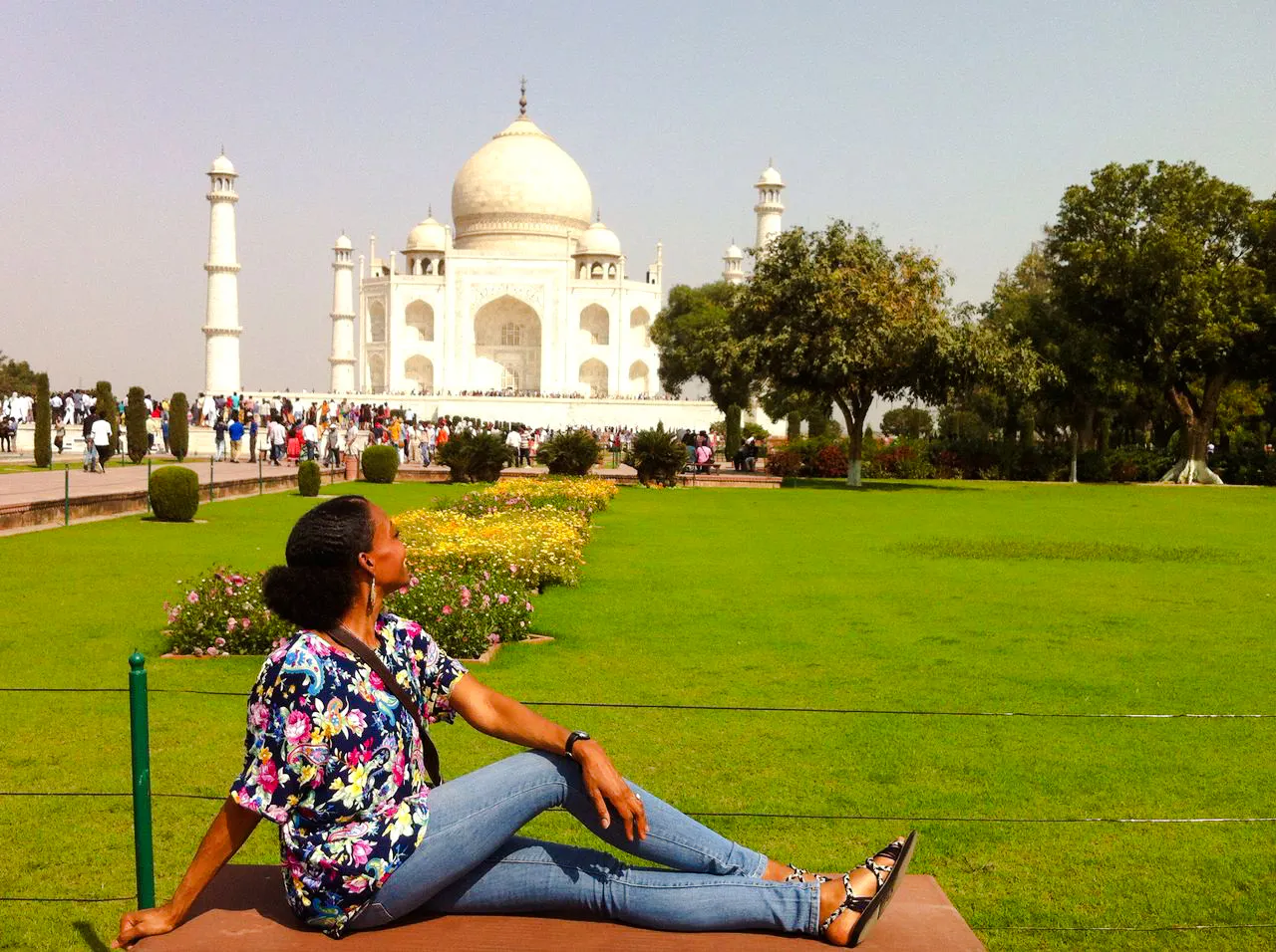 Visitor relaxing on a bench with the Taj Mahal in the background, Agra tour.