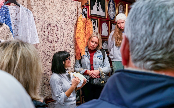 Tour group observing lace-making demonstration at Lace Museum in Burano.