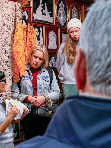 Tour group observing lace-making demonstration at Lace Museum in Burano.