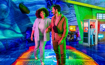 Couple exploring colorful interactive exhibit at Omega Mart, Las Vegas.