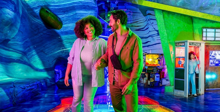Couple exploring colorful interactive exhibit at Omega Mart, Las Vegas.