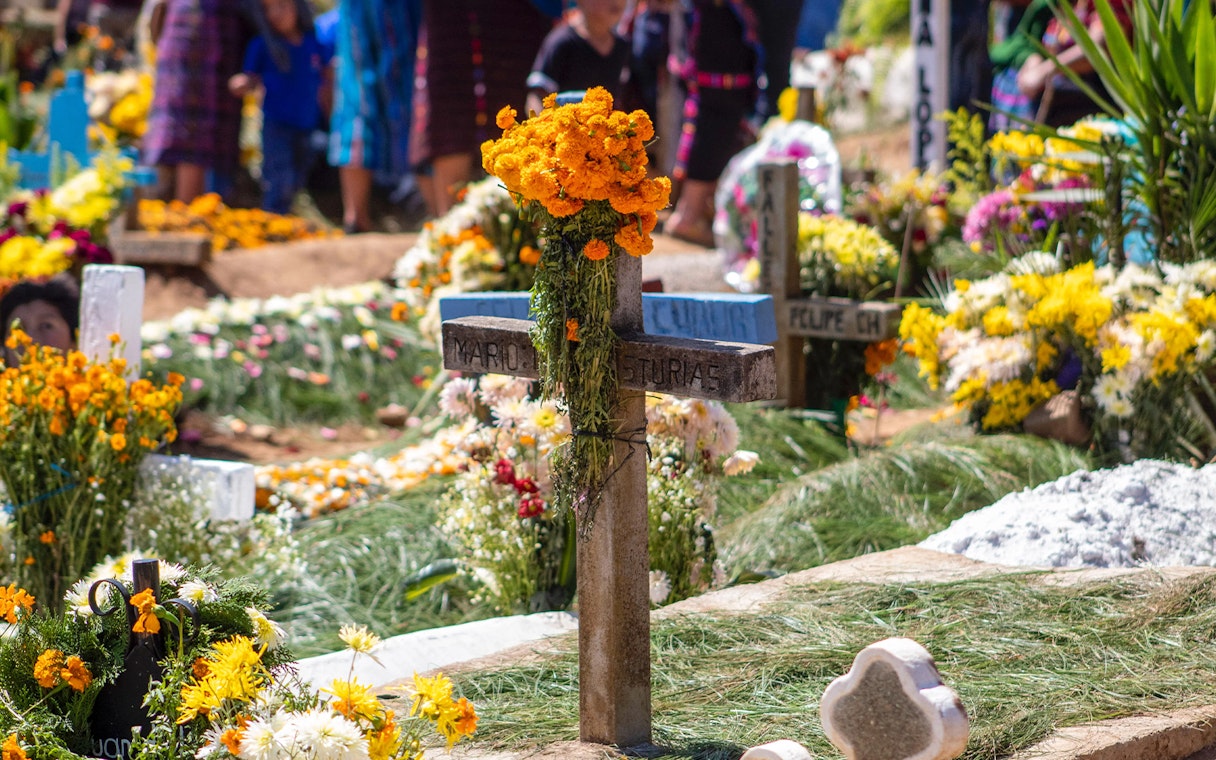 Grave adorned with marigolds during Day of the Dead celebration in Mexico.