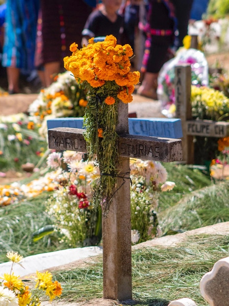 Grave adorned with marigolds during Day of the Dead celebration in Mexico.