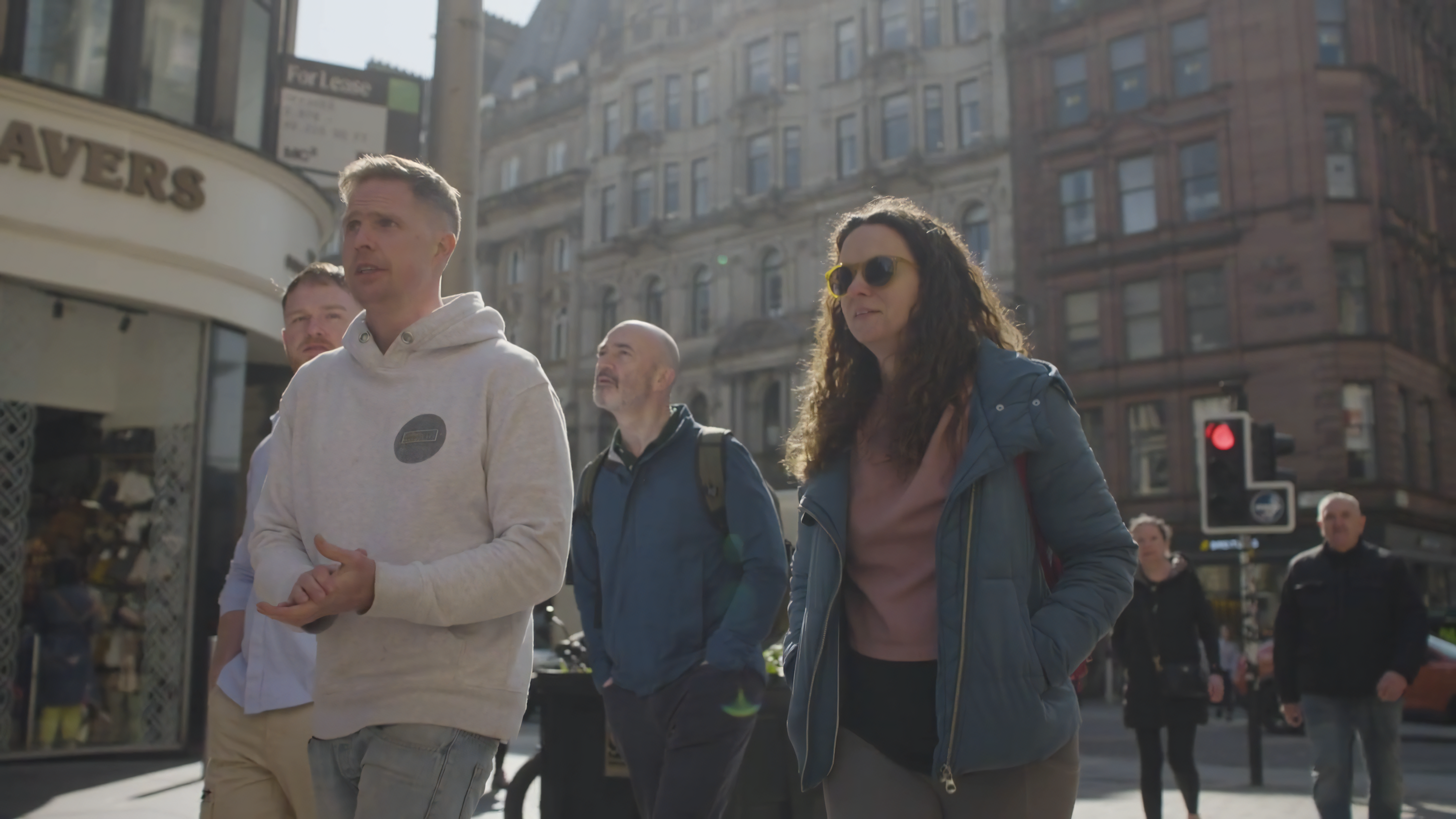 Group of people on a walking city tour in Glasgow's historic district.