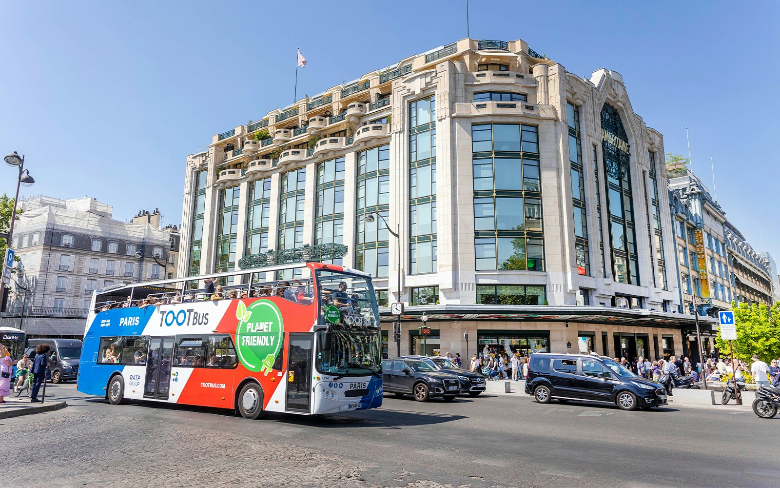 Paris hop-on hop-off bus passing Samaritaine department store.