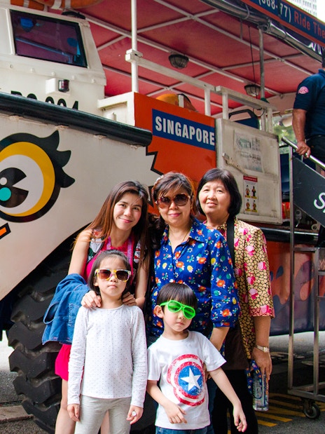 DUCKtours Singapore vehicle with a family posing in front.